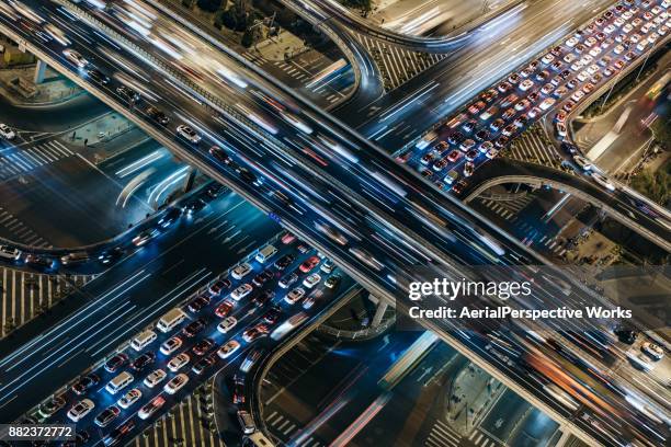 aerial view of crowded traffic at night - road junction stock pictures, royalty-free photos & images