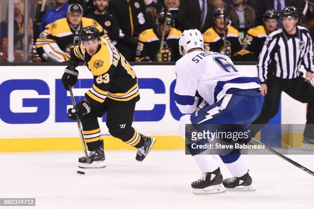 Brad Marchand of the Boston Bruins skates with the puck against Anton Stralman of the Tampa Bay Lightning at the TD Garden on November 29, 2017 in...