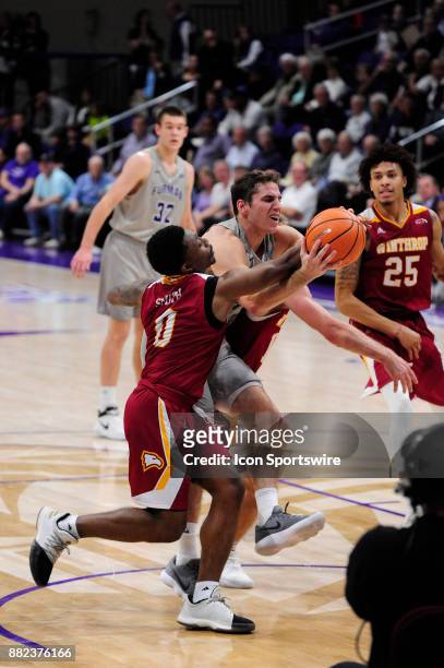 Andrew Brown guard Furman University Paladins attempts to drive between Nych Smith guard and Anders Broman guard Winthrop University Eagles, November...