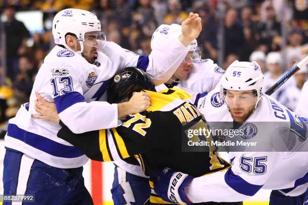 Braydon Coburn of the Tampa Bay Lightning attempts to separate Cedric Paquette and Frank Vatrano of the Boston Bruins during the second period at TD...
