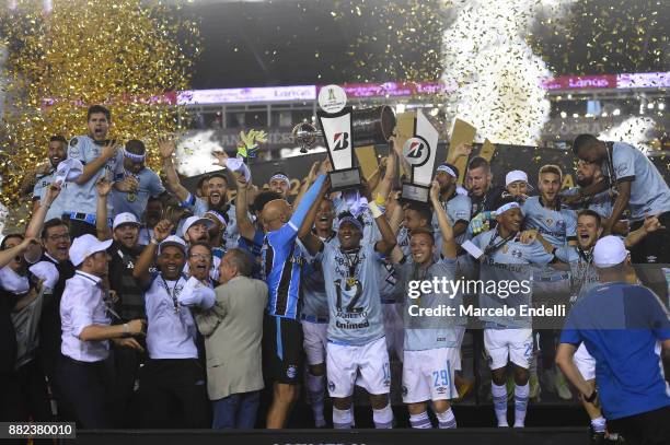 Geromel of Gremio lifts the champions trophy after the second leg match between Lanus and Gremio as part of Copa Bridgestone Libertadores 2017 Final...