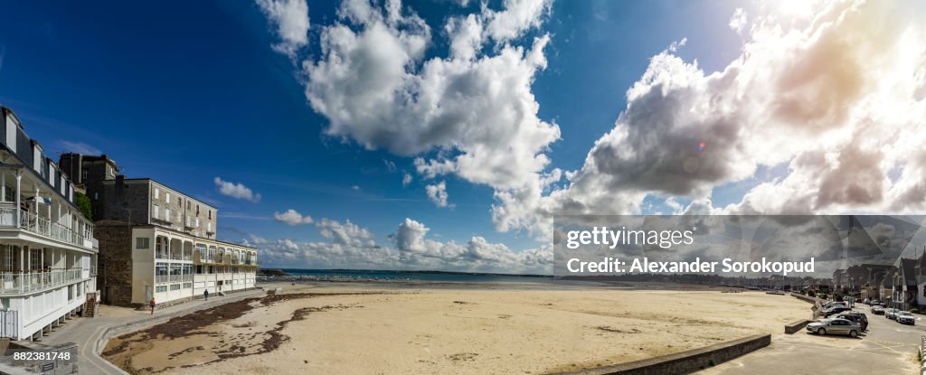 French resort autumn view. Yellow sand on long beach while low tide water, Brittany, France