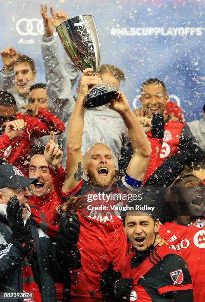 Michael Bradley of Toronto FC lifts the MLS Eastern Conference Finals trophy following victory in the 2nd leg against Columbus Crew SC at BMO Field...