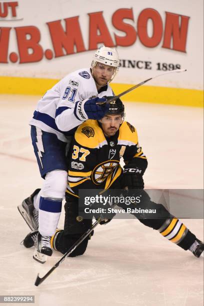Patrice Bergeron of the Boston Bruins against Steven Stamkos of the Tampa Bay Lightning at the TD Garden on November 29, 2017 in Boston,...