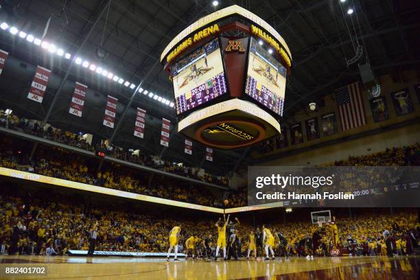 The Minnesota Golden Gophers tip-off against the Miami Hurricanes during the first half of the game on November 29, 2017 at Williams Arena in...