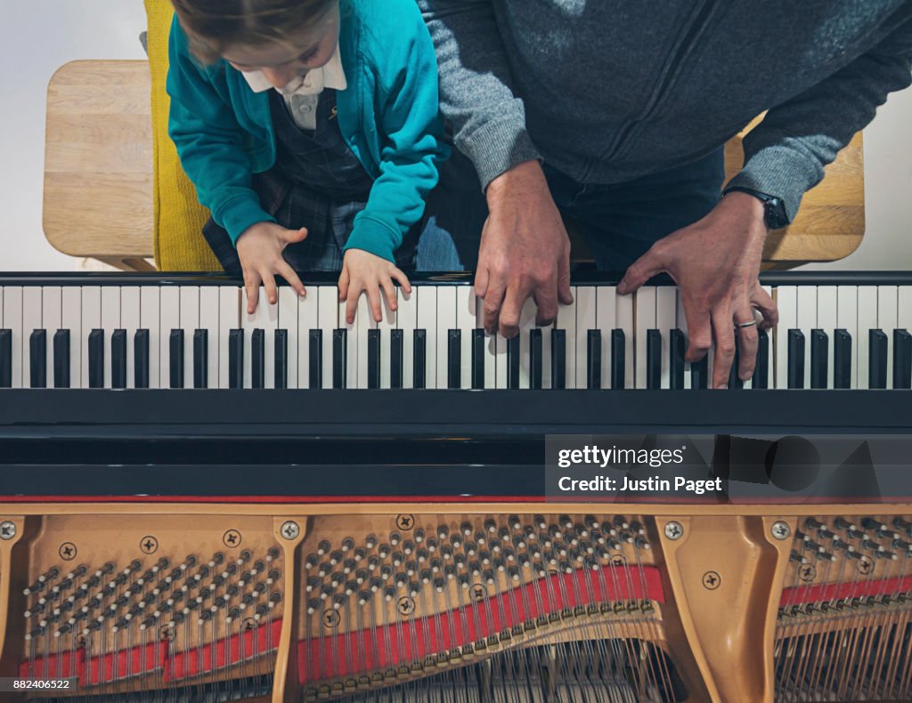 Father and daughter playing the piano