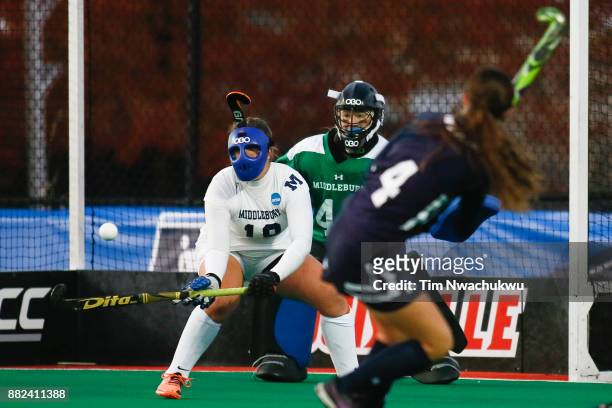 Olivia Green of Middlebury College tries to block a shot by Kaylor Rosenberry of Messiah College during the Division III Women's Field Hockey...