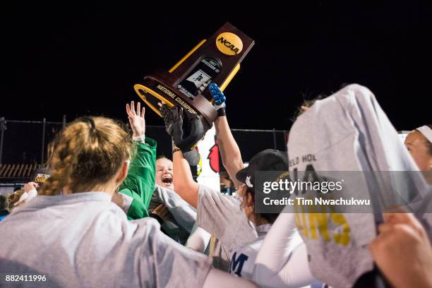 Middlebury College players celebrate with the national championship trophy during the Division III Women's Field Hockey Championship held at Trager...