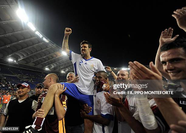 France's player Vincent Candela is acknowledged by former AS Roma teammate Daniele DE Rossi and Aldair of Brazil at the end of Candela's farewell...