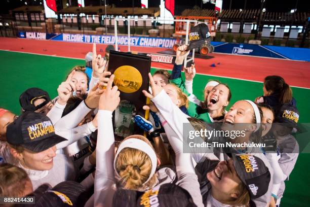 Middlebury College players celebrate with the national championship trophy during the Division III Women's Field Hockey Championship held at Trager...