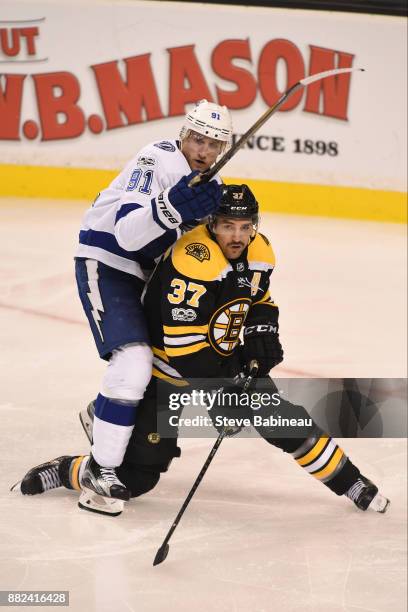 Patrice Bergeron of the Boston Bruins against Steven Stamkos of the Tampa Bay Lightning at the TD Garden on November 29, 2017 in Boston,...