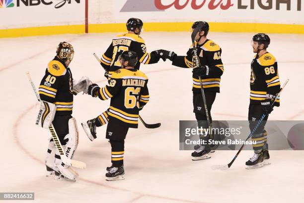 Tuukka Rask, Brad Marchand, Patrice Bergeron, David Backes and Kevan Miller of the Boston Bruins celebrate a win against the Tampa Bay Lightning at...