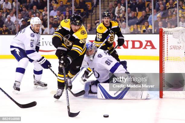 Tim Schaller of the Boston Bruins takes a shot against Andrei Vasilevskiy of the Tampa Bay Lightning during the third period at TD Garden on November...