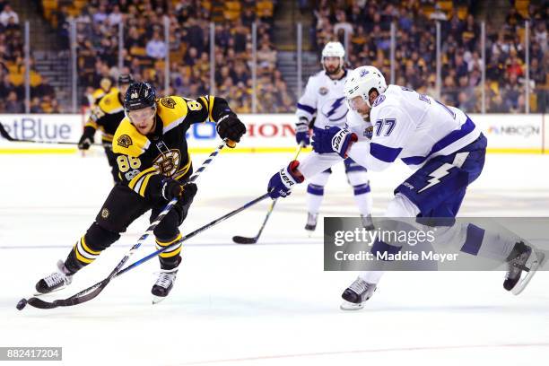 Victor Hedman of the Tampa Bay Lightning defends Kevan Miller of the Boston Bruins during the third period at TD Garden on November 29, 2017 in...
