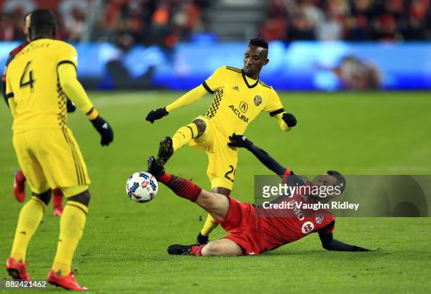 Sebastian Giovinco of Toronto FC battles for the ball with Harrison Afful of Columbus Crew SC during the second half of the MLS Eastern Conference...