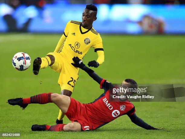 Sebastian Giovinco of Toronto FC battles for the ball with Harrison Afful of Columbus Crew SC during the second half of the MLS Eastern Conference...