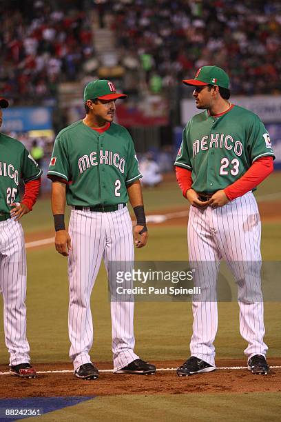 Second baseman Edgar Gonzalez of Mexico talks to first baseman Adrian Gonzalez of Mexico before playing Australia in the Pool B, game 5 in the first...
