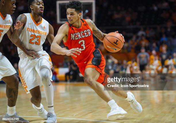 Mercer Bears guard Marcus Cohen drives around Tennessee Volunteers guard Jordan Bowden and forward Admiral Schofield during a game between the Mercer...