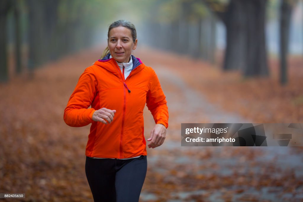 Women in Sport - woman jogging alone in autumn