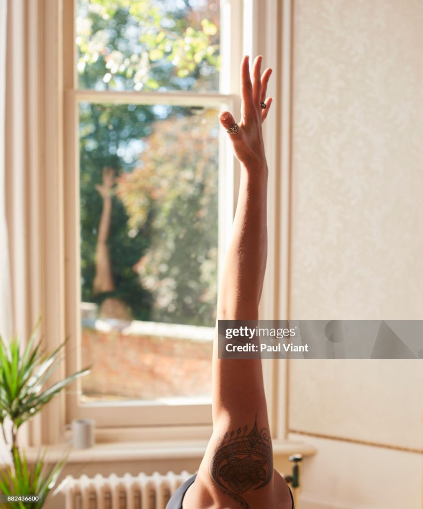 Crop shot of stretched out arm in yoga pose