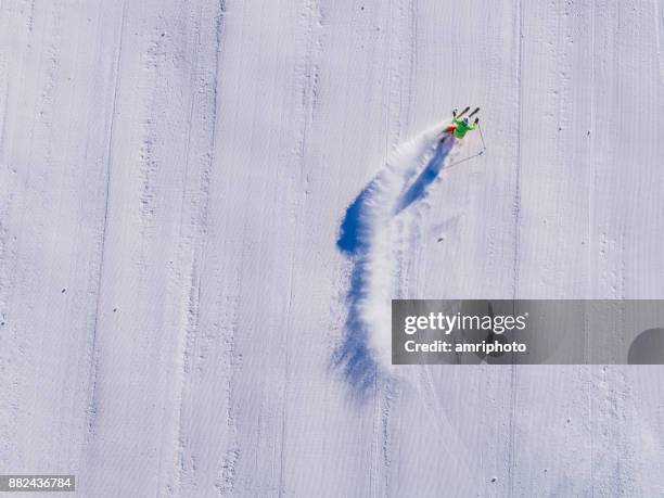 winter breaks - one skier skiing on ski piste aerial view - ski hill stock pictures, royalty-free photos & images