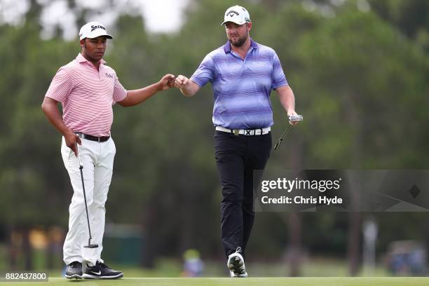 Harold Varner III and Marc Leishman celebrate a birdie put on the 8th hole during day one of the 2017 Australian PGA Championship at Royal Pines...