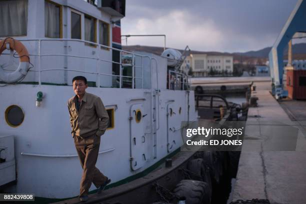 In a photo taken on November 21 a sailor stands on his boat in the port in Rason. At the northeastern tip of North Korea, where the isolated,...