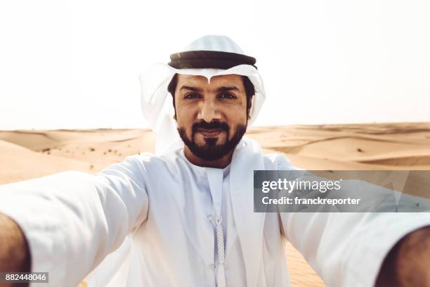 arabic man take a selfie in the desert - qatar people stock pictures, royalty-free photos & images