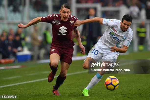 Andrea Belotti of Torino FC is challenged by Nenad Tomovic of AC Chievo Verona during the Serie A match between Torino FC and AC Chievo Verona at...
