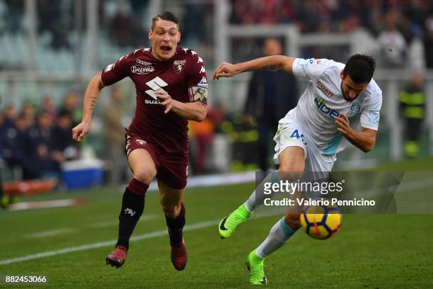 Andrea Belotti of Torino FC is challenged by Nenad Tomovic of AC Chievo Verona during the Serie A match between Torino FC and AC Chievo Verona at...