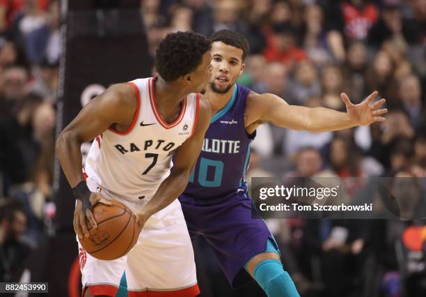 Michael Carter-Williams of the Charlotte Hornets guards Kyle Lowry of the Toronto Raptors during NBA game action at Air Canada Centre on November 29,...