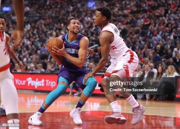 Michael Carter-Williams of the Charlotte Hornets tries to get past Kyle Lowry of the Toronto Raptors during NBA game action at Air Canada Centre on...
