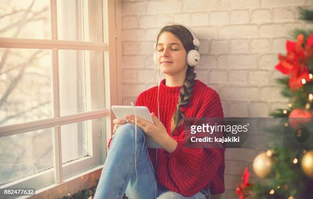 teenage girl at home for christmas - christmas music listen stock pictures, royalty-free photos & images