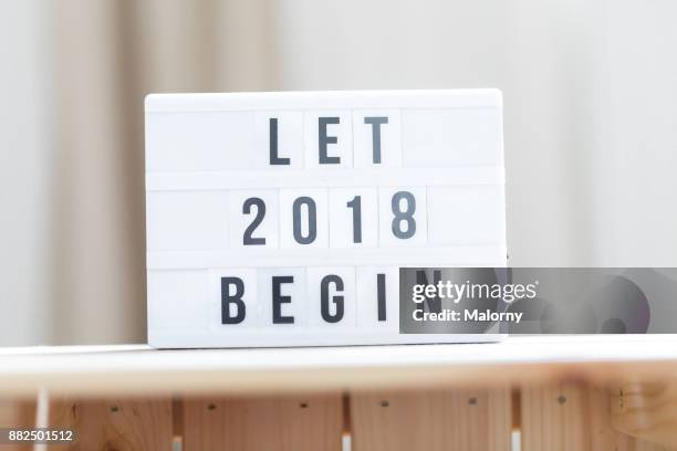 let 2018 begin: happy new year sign. - lightbox message stock pictures, royalty-free photos & images