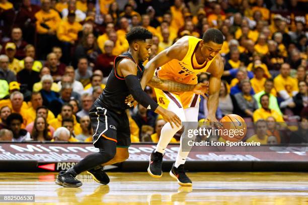 Minnesota Golden Gophers guard Isaiah Washington is fouled by Miami Hurricanes guard Chris Lykes during the non-conference game between the Miami...