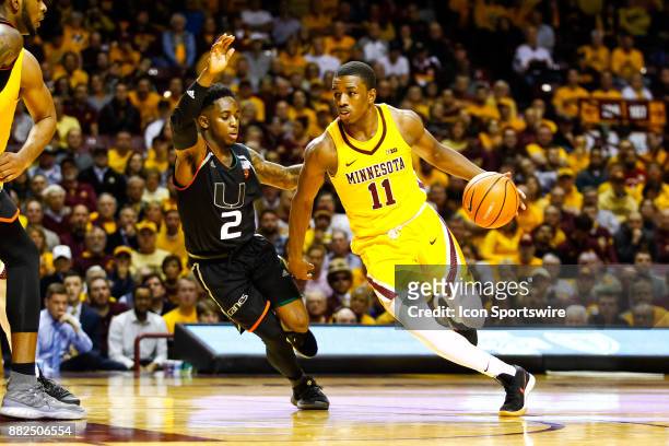Minnesota Golden Gophers guard Isaiah Washington drives to the net while Miami Hurricanes guard Chris Lykes defends during the non-conference game...