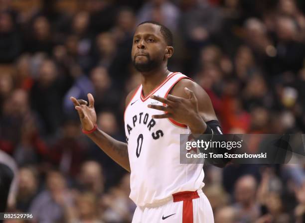 Miles of the Toronto Raptors celebrates after scoring a three-pointer against the Charlotte Hornets during NBA game action at Air Canada Centre on...