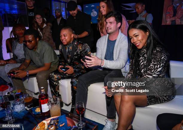 University of Michigan football players Wilton Speight plays XBox with Deelishis at the H.O.M.E. By Martell event on November 29, 2017 in Detroit,...