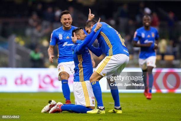 Eduardo Vargas Anselmo Vendrechovski Juninho and Andre-Pierre Gignac of Tigres celebrate their team's first goal during the semifinal first leg match...