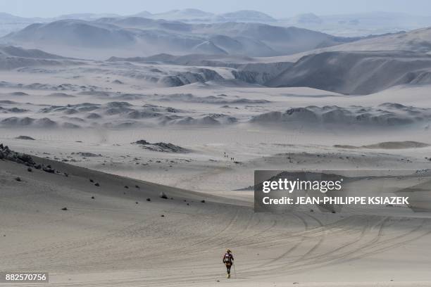 Competitors take part in the second stage of the first edition of the Marathon des Sables Peru between Coyungo and Samaca in the Ica Desert on...