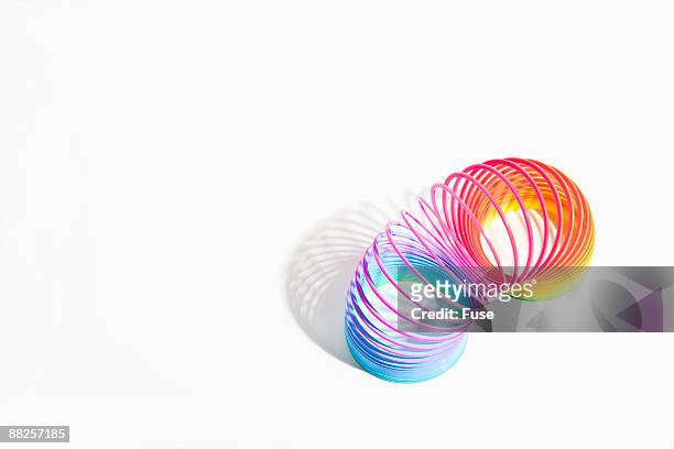 multicolor slinky - metal coil stock pictures, royalty-free photos & images