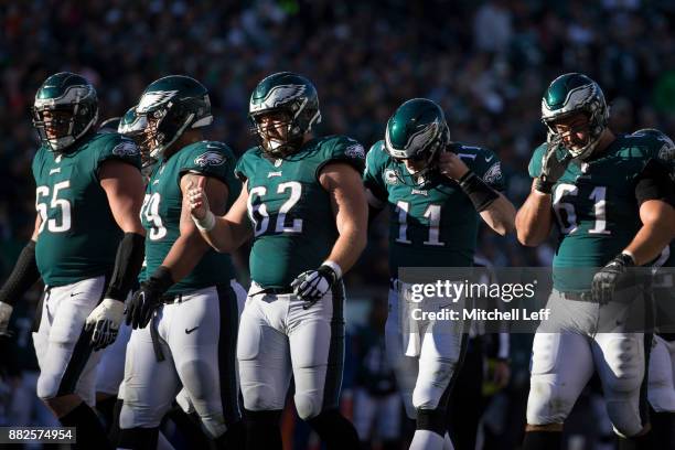 Lane Johnson, Brandon Brooks, Jason Kelce, Carson Wentz, and Stefen Wisniewski of the Philadelphia Eagles break the huddle against the Chicago Bears...