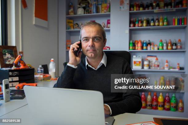 In this photograph taken on November 28 Chief Executive Officer of Cléopâtre glue company Alexandre Marionnet speaks on the telephone at the company...