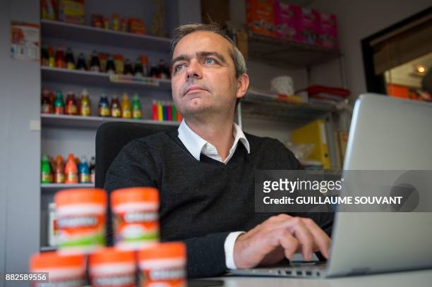 In this photograph taken on November 28 Chief Executive Officer of Cléopâtre glue company Alexandre Marionnet works on his computer at the company...