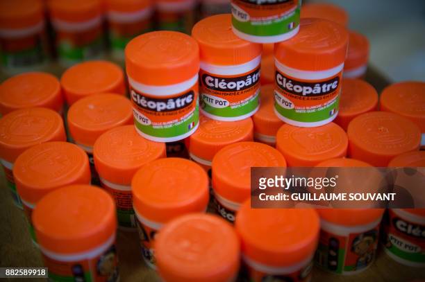 This photograph taken on November 28 shows a cluster of Cléopâtre glue "ptit pots" at the company's manufacturing plant at Ballan-Mire in central...