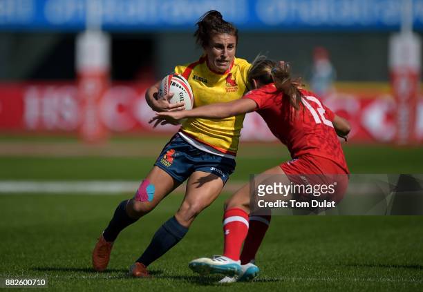 Maria Casado of Spain is tacked by Megan Lukan of Canada during Day One of the Emirates Dubai Rugby Sevens - HSBC Sevens World Series match between...