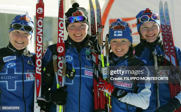 Aino Kaisa Saarinen, Virpi Kuitunen, Riita Liisa Lassila and Kaisa Varis of Filand pose on the podium of the women's Relay 4x5 km of the...