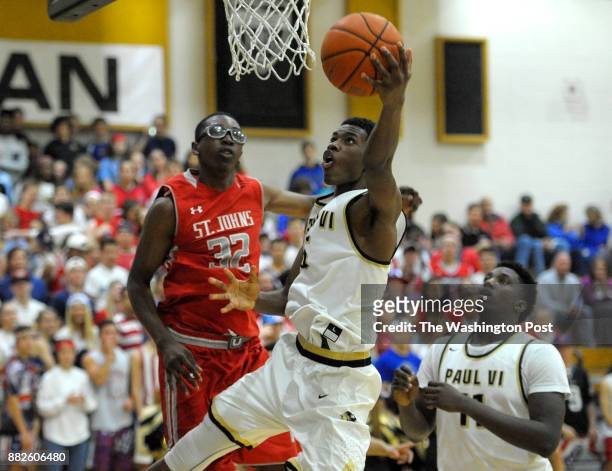 Paul VI Panthers guard Brandon Slater drives to the hoop around St. John's Cadets forward Richard Njoku in the second half December 10, 2015 in...