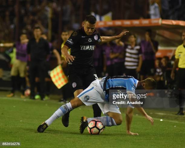Maximiliano Velazquez of Lanus fights for the ball with Luan Guilherme de Jesus Vieira of Gremio during Copa Libertadores final match between Lanus...