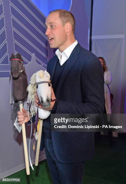 The Duke of Cambridge is presented with two hobby horses as he attends the tech festival Slush in Helsinki, Finland.